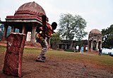 K-27 (Backyard Cricket) A game of cricket among the historic ruins in Mehrauli, Delhi.