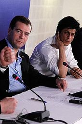 Shah Rukh Khan seated on a panel with Dmitry Medvedev in 2010