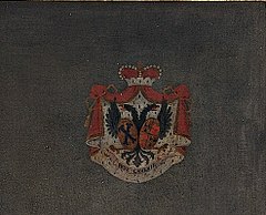 Red, white and blue coat of arms against a dark flat background
