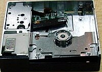 DataPlay optical drive engine internals viewed from above a unit produced without any top cover; above the circular piece is the laser pickup. The laser pickup is built on a piece of silicon.[17]