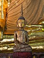 A wooden Thai Lue Buddha statue inside Wat Nong Bua, Tha Wang Pha District, Thailand