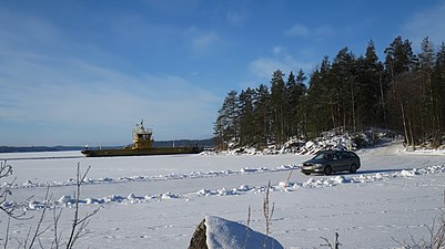Koivukanta ferry in winter and parallel ice road for lighter vehicles
