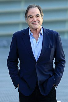 Black-and-white picture of Oliver Stone looking to the camera.