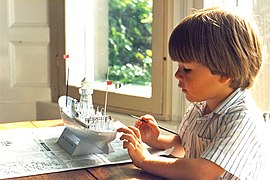 4-year-old boy painting a Revell plastic model of the South Goodwin Lightship