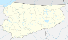 Mapa konturowa województwa warmińsko-mazurskiego, blisko centrum na lewo znajduje się punkt z opisem „Spręcowo”