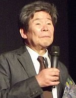 Isao Takahata holding a microphone