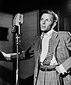 Frank Sinatra wearing the pleated trousers fashionable in 1947.