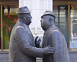 Statue of two businessmen talking