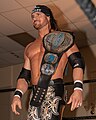 Johnny Impact with the fifth design of the belt, introduced in 2018, in its original blue-painted version
