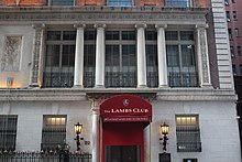 The entrance to the Lambs Club restaurant, with a red awning above it
