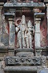 Shiva with Parvati in abhaya mudra, warrior panels below them.