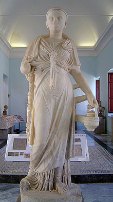 Statue of a woman holding a jug or basket