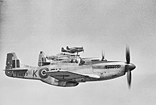 Five World War II-era propeller driven fighters in the air