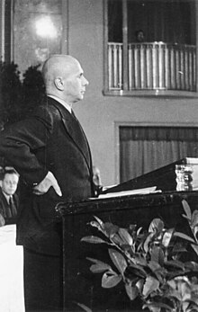 Kaiser standing at podium