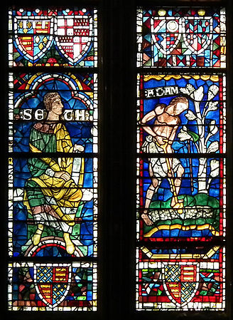 Two panels of lively figures, Seth and Adam from the 12th-century Ancestors of Christ, Canterbury Cathedral, now set into a Perpendicular Gothic window with panels of many different dates.