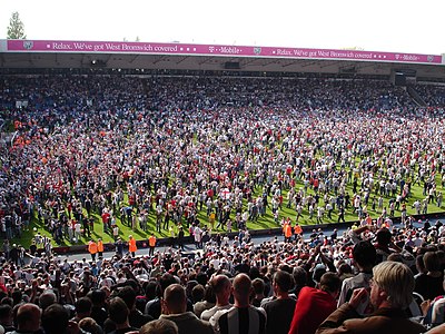 Supporters of West Bromwich Albion invade the pitch after the final whistle to celebrate the "Great Escape" of avoiding relegation on the last day of the 2004-05 season