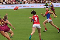 Pearce handballing a football