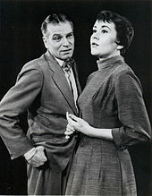 middle aged man with young woman on stage