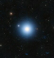 A large blue star in an ocean of other stars taken by telescope