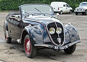 Peugeot 202 cabriolet. The protected position of the headlights behind the grill became a key identifier for the Peugeot brand during the 1930s.