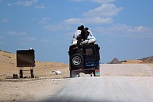 A packed jeep moving in the desert of Tharparkar