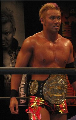 Four-time and current champion Kazuchika Okada with the IWGP Heavyweight Championship belt