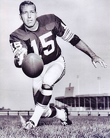 Full body photo of Bart Starr in his uniform tossing a football towards the camera