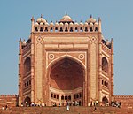 A large gate in red stone in Mughal style