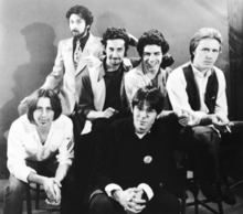 Promotional picture for Contents Dislodged During Shipment, 1979 Left to right: Chris Butler, Harvey Gold, Michael Aylward, Ralph Carney, Mark Price, Stuart Austin