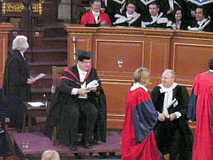 Scarlet academic gowns are worn by new Doctors of Philosophy at a degree ceremony at Oxford University.