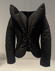 Black puffer jacket with exaggerated lapels that extend vertically