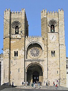 Lisbon Cathedral, Portugal, 1147, has a similar form to the Old Cathedral of Coimbra above with the addition of two sturdy bell towers in the Norman manner and a wheel window.