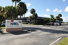 A one-story office building with a WXEL sign outside