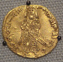 Coin with protruded inscription in Arabic and a bearded man standing with sheathed sword, seen face-on