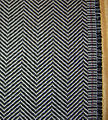 Ejemplo del patrón herringbone, una opción popular para trajes y prendas exteriores.