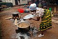 Image 30A Tanzanian woman cooks Pilau rice dish wearing traditional Kanga. (from Tanzania)