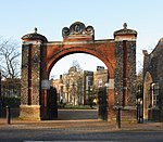 Entrance archway and gates at Pitzhanger Manor at north-east end of park