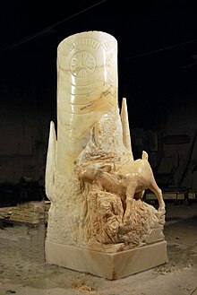 Statuette en marbre d'une structure cylindrique près d'un animal