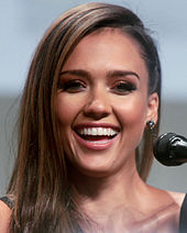 A portrait shot of Jessica Alba, an attractive woman with long brown hair, smiling
