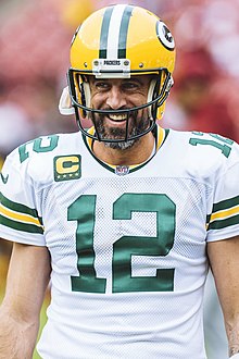 Rodgers smiling in his uniform and helmet