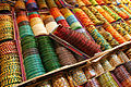 Image 2 Bangles Photograph: Muhammad Mahdi Karim Bangles on display in Bangalore, India. These rigid bracelets are usually made from metal, wood, or plastic and are traditionally worn by women in India, Nepal, Pakistan, and Bangladesh. In India, it is a common tradition to see a new bride wearing glass bangles at her wedding and the honeymoon will end when the last bangle breaks. More selected pictures
