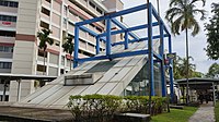 Photograph of Serangoon station entrance, encased in a blue cubic structure