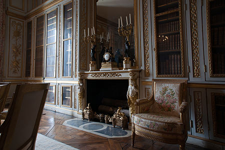 Neoclassical fireplace in the Bibliothèque de Louis XVI, Palace of Versailles, designed by Ange-Jacques Gabriel and decorated with bronzes made by Pierre Gouthière, 1774