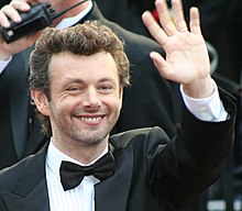 Close-up of Sheen outdoors, smiling and waving