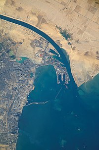 Satellite view o the port an ceety that are the soothren terminus o the Suez Canal that transits throu Egyp an debouches intae the Mediterranean Sea near Port Said. (Up is north-east).