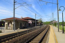 A railway station with a Spanish-style station building