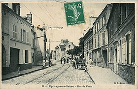 La rue de Paris. Le tracé historique de la RN 14 est alors parcourue par le tramway Enghien - Trinité. C'est l'ancêtre du T8.