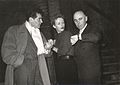 Emil-Edwin Reinert, Joan Camden, and Francis Lederer in a production of Stolen Identity, Vienna, 1952. Lederer (left) wears a broad-shouldered overcoat and scarf