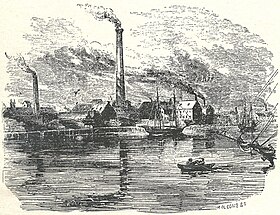 factory near water with smokestacks