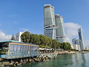 A ground view of the Limassol seafront, with the Trilogy buildings and the Limassol One building triumphing over the city